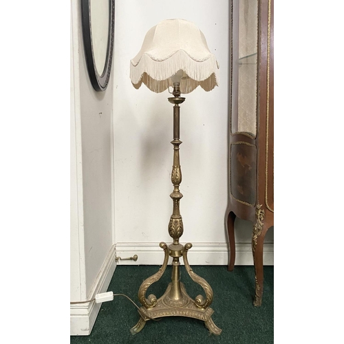 86 - A DECORATIVE GILT FLOOR LAMPSHADE, with turned engraved column on shaped tripod base supported by sc... 