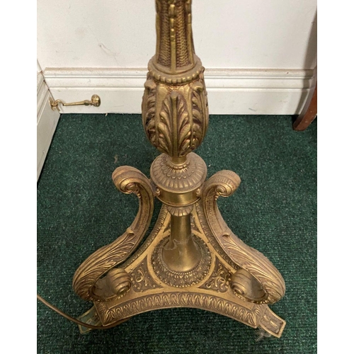 86 - A DECORATIVE GILT FLOOR LAMPSHADE, with turned engraved column on shaped tripod base supported by sc... 