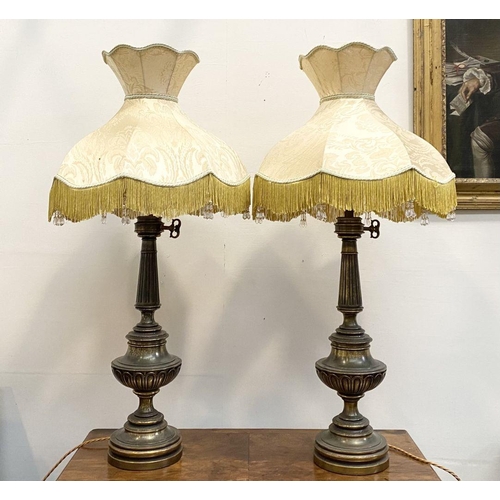 92 - A PAIR OF LARGE ORNATE BRASS TABLE LAMPS, with gilt decorative supports atop circular platform base,... 