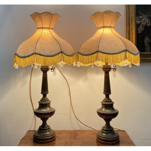 92 - A PAIR OF LARGE ORNATE BRASS TABLE LAMPS, with gilt decorative supports atop circular platform base,... 