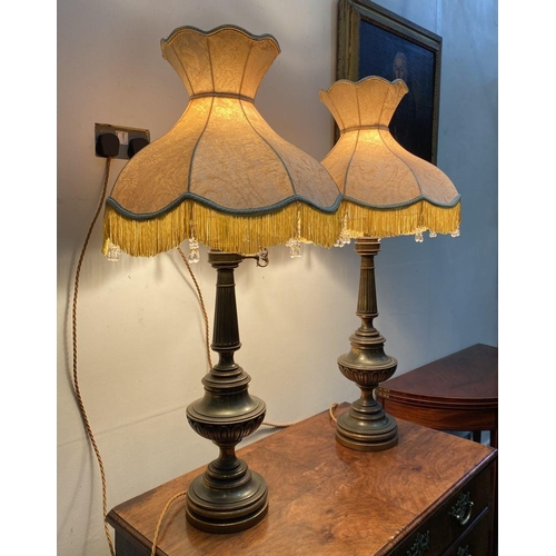 92 - A PAIR OF LARGE ORNATE BRASS TABLE LAMPS, with gilt decorative supports atop circular platform base,... 