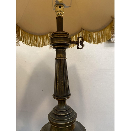 92 - A PAIR OF LARGE ORNATE BRASS TABLE LAMPS, with gilt decorative supports atop circular platform base,... 