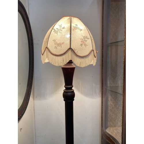 94 - AN ANTIQUE MAHOGANY FLOOR LAMP, with turned support on circular base, complete with lampshade with f... 