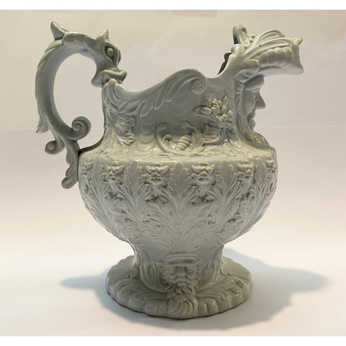 333 - AN ANTIQUE STAFFORDSHIRE FIGURAL MASK JUG, with dragon design handle, foliage design surrounding. Di... 