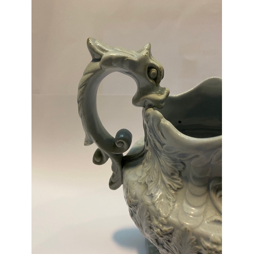 333 - AN ANTIQUE STAFFORDSHIRE FIGURAL MASK JUG, with dragon design handle, foliage design surrounding. Di... 