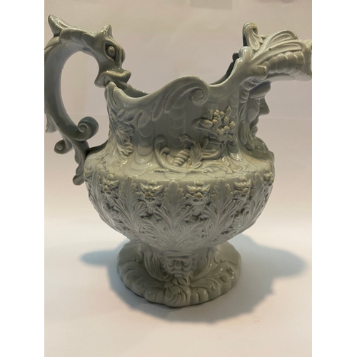 333 - AN ANTIQUE STAFFORDSHIRE FIGURAL MASK JUG, with dragon design handle, foliage design surrounding. Di... 