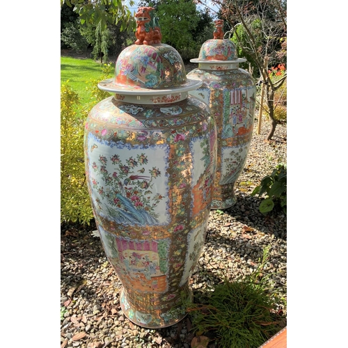 28 - AN EXCEPTIONAL PAIR OF LARGE FAMILLE ROSE CHINESE URN/PALACE VASES, finely decorated with painted fi... 