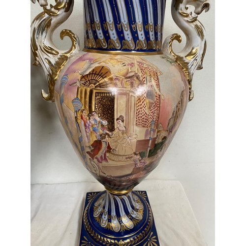 59 - A PAIR OF CONTINENTAL PROCELAIN VASE URNS, each with a pair of dragon handles to the sides, the neck... 