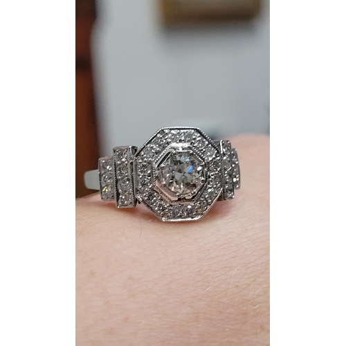 8 - A STUNNING ART DECO INSPIRED PLATINUM DIAMOND RING, with a central diamond in an octagonal shaped se... 