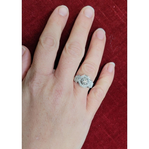 8 - A STUNNING ART DECO INSPIRED PLATINUM DIAMOND RING, with a central diamond in an octagonal shaped se... 