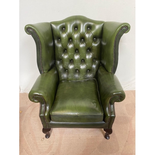9 - A PAIR OF GOOD QUALITY GREEN BUTTON BACKED WINGED LEATHER ARM CHAIRS IN THE CHESTERFIELD STYLE, with... 