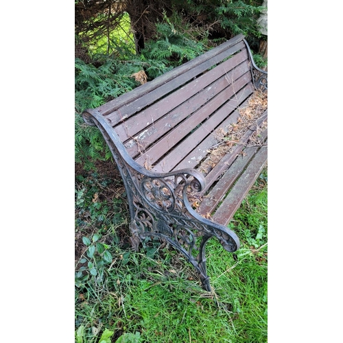 184 - A CAST IRON FRAMED GARDEN SEAT, on each side are cast iron frames with lion head & run design surrou... 