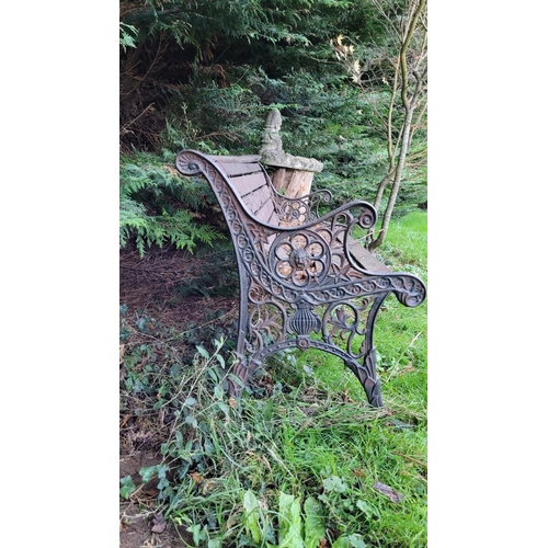 184 - A CAST IRON FRAMED GARDEN SEAT, on each side are cast iron frames with lion head & run design surrou... 
