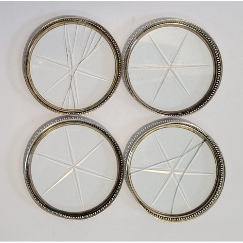 246 - A SILVER GLASS BOTTOMED TRIVET, with a set of four sterling rimmed glass bottomed coasters, the triv... 