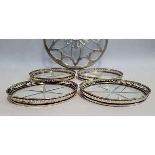 246 - A SILVER GLASS BOTTOMED TRIVET, with a set of four sterling rimmed glass bottomed coasters, the triv... 