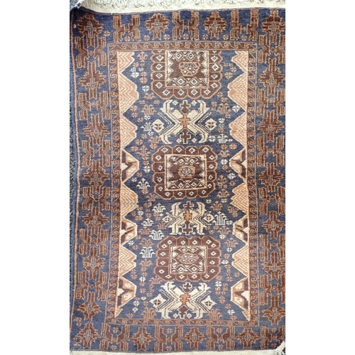 106 - AN AFGHAN BELOUCH FLOOR RUG, with overall ground colour blue; to the outside border are floral shape... 