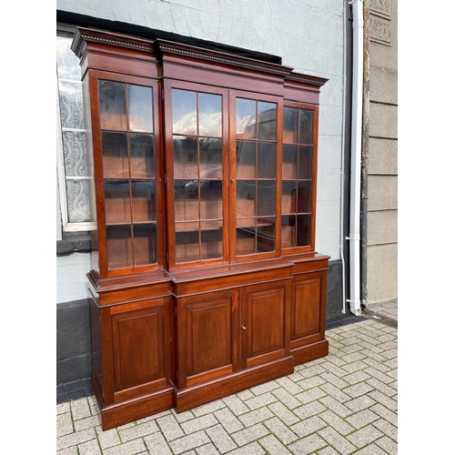 115 - A VERY GOOD QUALITY MAHOGANY LIBRARY BREAKFRONT GLAZED BOOKCASE, with stepped pediment having dentil... 