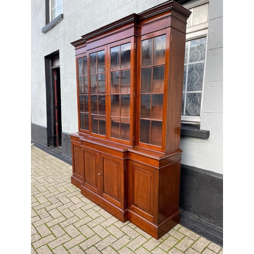 115 - A VERY GOOD QUALITY MAHOGANY LIBRARY BREAKFRONT GLAZED BOOKCASE, with stepped pediment having dentil... 