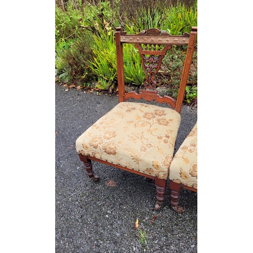 117 - A LOVELY PAIR OF EDWARDIAN LOW RISE ‘NURSING’ / BEDROOM CHAIRS, each with a carved & pierced back re... 