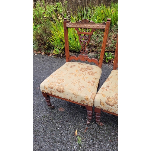 117 - A LOVELY PAIR OF EDWARDIAN LOW RISE ‘NURSING’ / BEDROOM CHAIRS, each with a carved & pierced back re... 