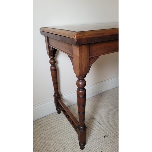 129 - AN ANTIQUE MAHOGANY FOLD OVER CARD TABLE, the top with a graduated edge that meets the frame beneath... 