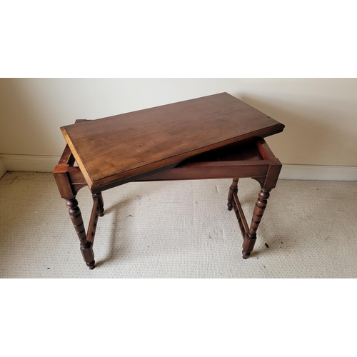 129 - AN ANTIQUE MAHOGANY FOLD OVER CARD TABLE, the top with a graduated edge that meets the frame beneath... 