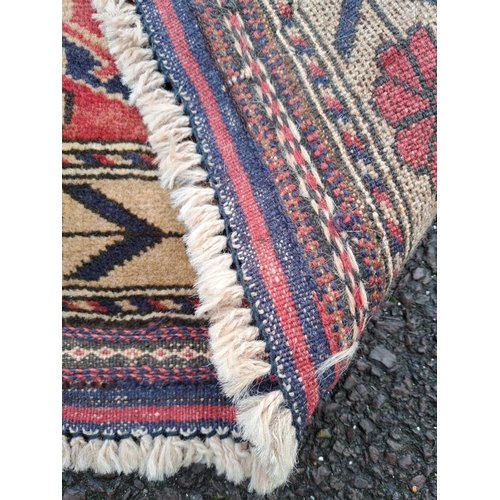 16 - A GOOD QUALITY AFGHAN BELOUCH FLOOR RUG, with deep floral border with a rope design border on each s... 