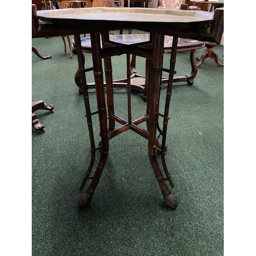 169 - AN ANTIQUE ANGLO/INDIAN FOLDING SIDE TABLE, decorative brass embossed shaped top with raised border,... 