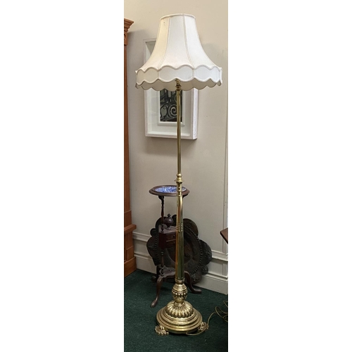 174 - A FINE POLISHED BRASS FLOOR LAMP, turned support on shaped circular platform base, on three decorati... 