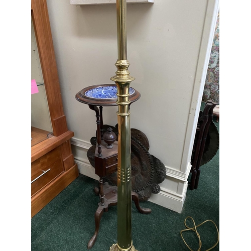 174 - A FINE POLISHED BRASS FLOOR LAMP, turned support on shaped circular platform base, on three decorati... 