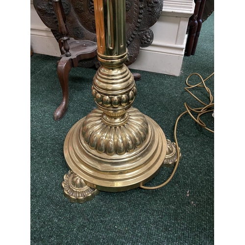 174 - A FINE POLISHED BRASS FLOOR LAMP, turned support on shaped circular platform base, on three decorati... 