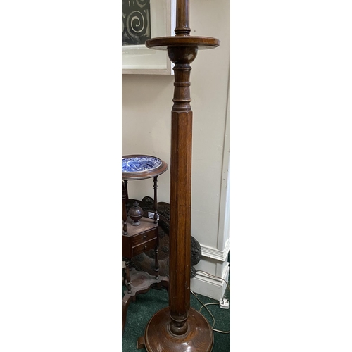 176 - A VINTAGE CARVED MAHOGANY FLOOR LAMP, with turned support on circular platform base with three feet.... 