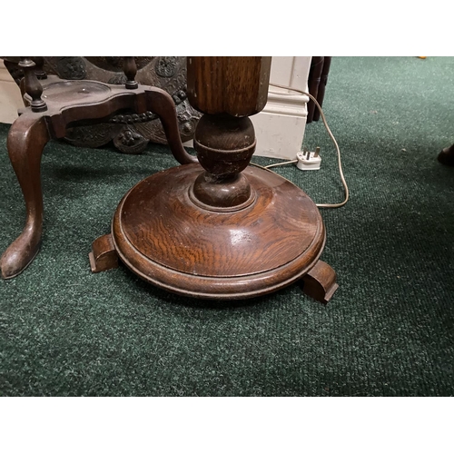 176 - A VINTAGE CARVED MAHOGANY FLOOR LAMP, with turned support on circular platform base with three feet.... 