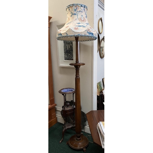 176 - A VINTAGE CARVED MAHOGANY FLOOR LAMP, with turned support on circular platform base with three feet.... 