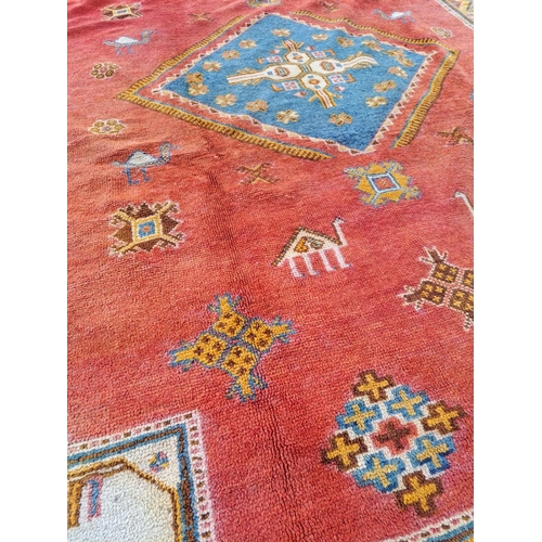 18 - A BRIGHT & COLOURFUL MOROCCAN FLOOR RUG, with large central diamond shaped medallion with blue main ... 