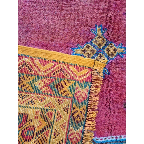 18 - A BRIGHT & COLOURFUL MOROCCAN FLOOR RUG, with large central diamond shaped medallion with blue main ... 