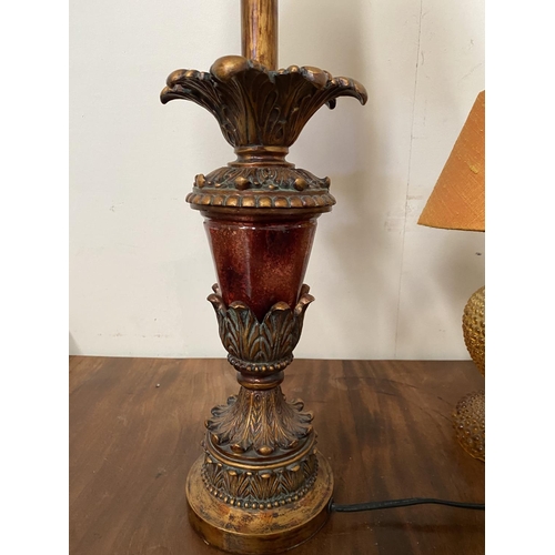 182 - A DECORATIVE AMBER GLASS GILT TABLE LAMP, with shaped support atop circular platform base and fringe... 