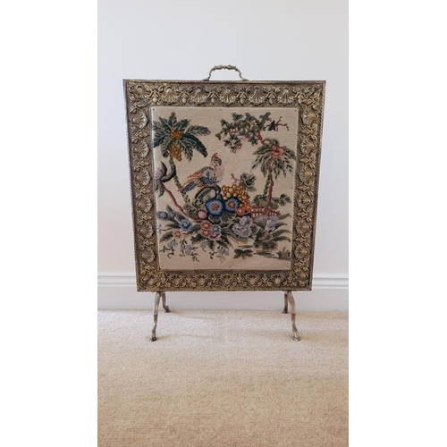 196 - AN ARTS N CRAFTS BRASS FRAMED FIRE SCREEN, the frame to the front with embossed floral & shell desig... 