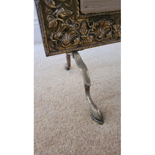 196 - AN ARTS N CRAFTS BRASS FRAMED FIRE SCREEN, the frame to the front with embossed floral & shell desig... 