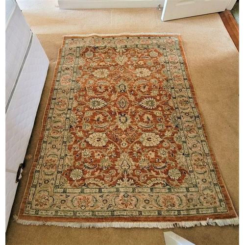 198 - A GOOD QUALITY FLORAL PATTERN FLOOR RUG, main ground colour amber, the central section decorated wit... 