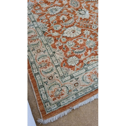 198 - A GOOD QUALITY FLORAL PATTERN FLOOR RUG, main ground colour amber, the central section decorated wit... 