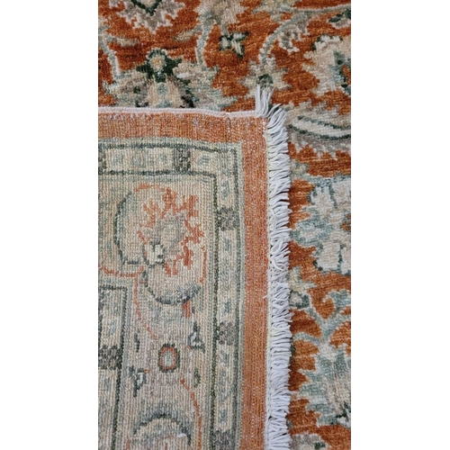 198 - A GOOD QUALITY FLORAL PATTERN FLOOR RUG, main ground colour amber, the central section decorated wit... 