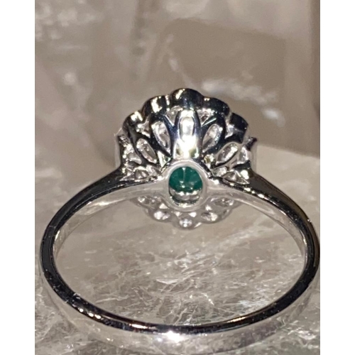 20 - AN 18CT WHITE GOLD EMERALD AND DIAMOND CLUSTER RING, emerald surrounded by 10 brilliant cut diamonds... 