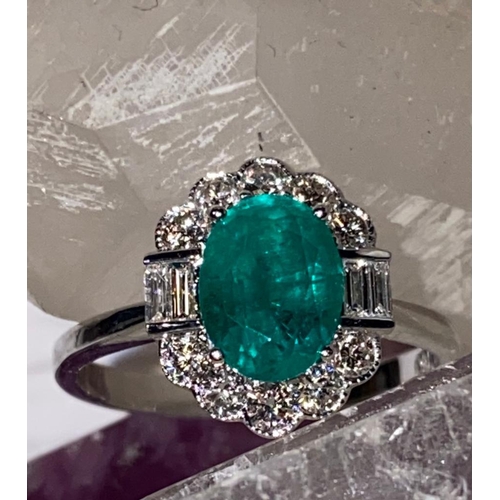 20 - AN 18CT WHITE GOLD EMERALD AND DIAMOND CLUSTER RING, emerald surrounded by 10 brilliant cut diamonds... 