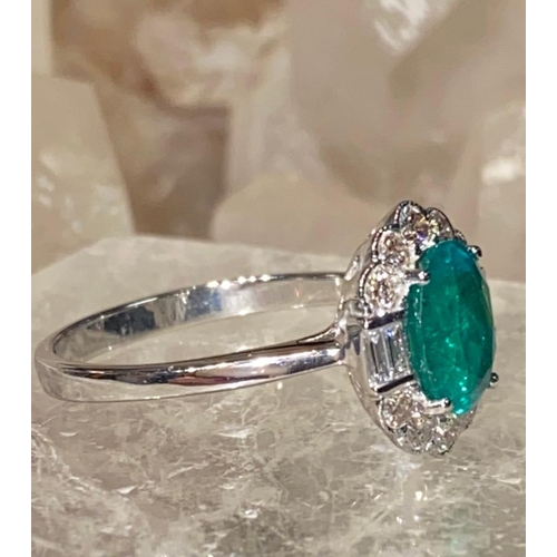 20 - AN 18CT WHITE GOLD EMERALD AND DIAMOND CLUSTER RING, emerald surrounded by 10 brilliant cut diamonds... 