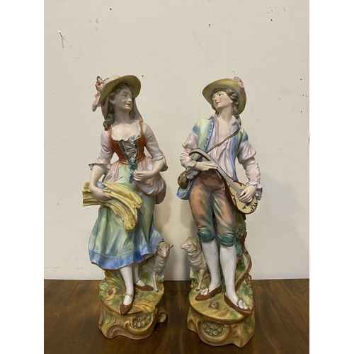 207 - A PAIR OF ANTIQUE PORCELAIN FIGURINES, in the form of male and female figures in traditional dress, ... 