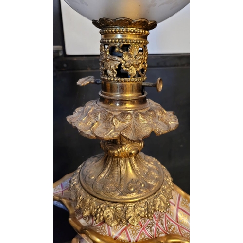 208 - AN IMPRESSIVE PAIR OF FRENCH PORCELAIN & BRASS OIL LAMPS, each with a detailed porcelain base, one w... 