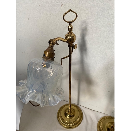 21 - A PAIR OF VINTAGE ADJUSTABLE BRASS TABLE LAMPS each with a glass shade with scalloped rim, the head ... 