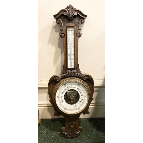 211 - AN ANTIQUE CARVED MAHOGANY BAROMETER, dial reading ‘Stormy, Rain, Chang, Fair, Very Dry’ within heav... 