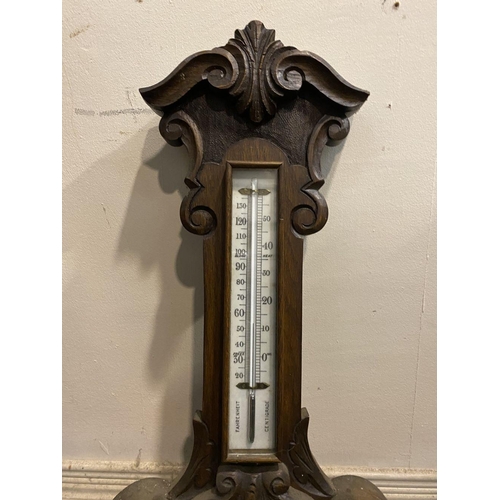 211 - AN ANTIQUE CARVED MAHOGANY BAROMETER, dial reading ‘Stormy, Rain, Chang, Fair, Very Dry’ within heav... 